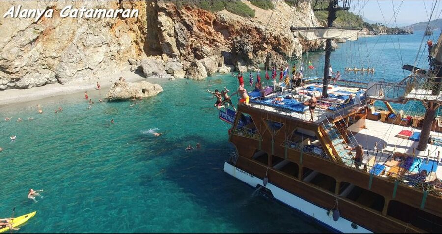 Alanya: Catamaran Boat Trip with Swim Stops and Sunbathing - The first views: Red Tower, shipyard, and castle coast