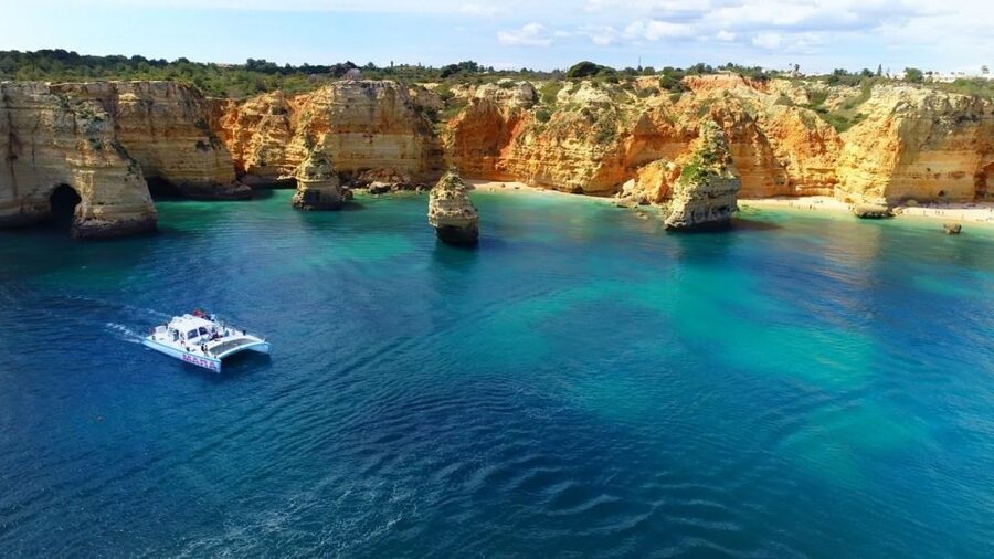 Albufeira: Catamaran Cruise with BBQ & Open Bar on the Beach - Benagil and the caves, seen from a moving boat