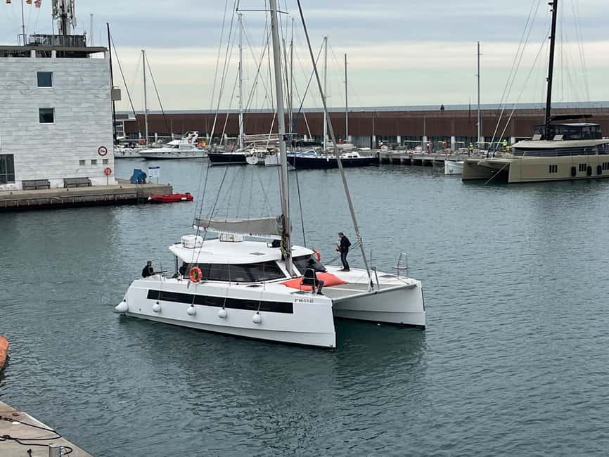 Barcelona: Shared cruise on a catamaran Drink+Local Tapa - Barcelona from the water, with the city spread inland