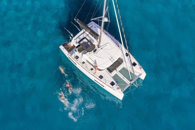 Catamaran Day & Sunset Cruises with meals Drinks and transportation - Baos and the view toward Delos