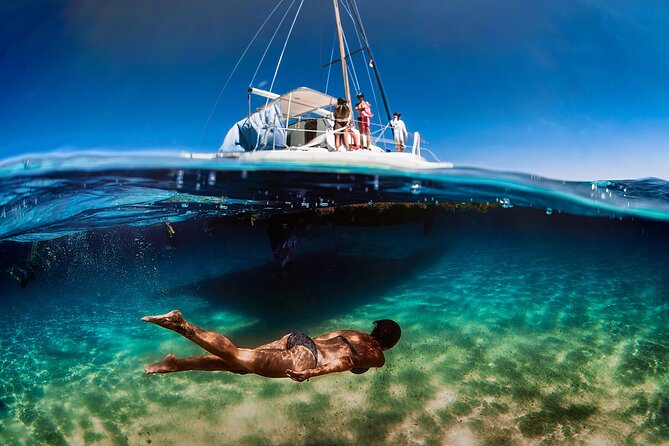 Discover Isla Mujeres: Catamaran, Snorkeling, and "Ice Bar" - Sailing from Cancun with a drink in hand