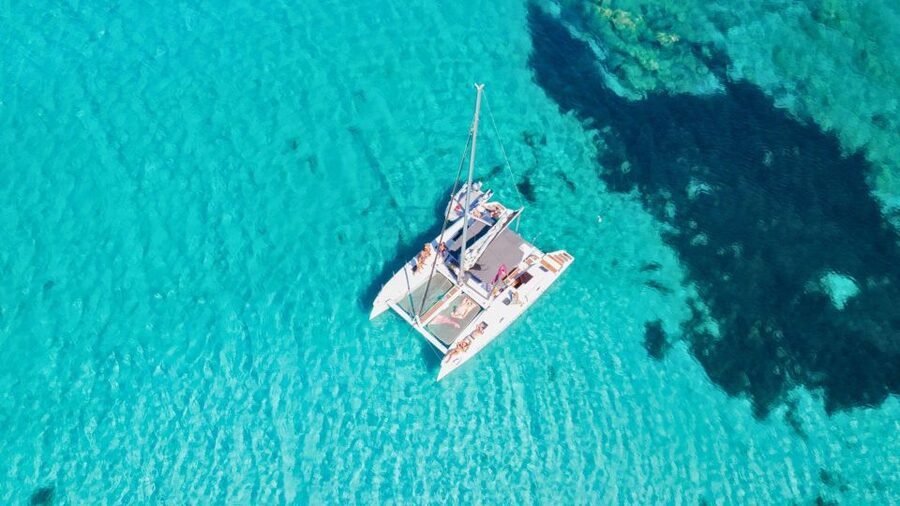From Cannigione: Catamaran tour among La Maddalena islands - Santa Maria, Razzoli, or Caprera depending on the day