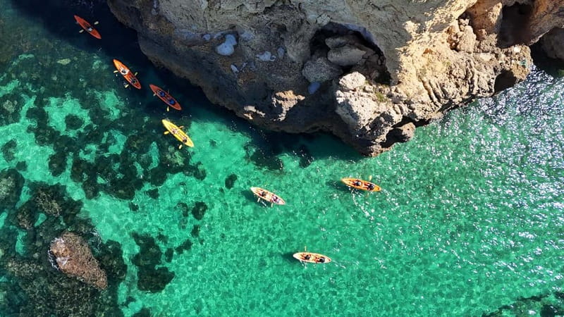 From Lagos: Ponta da Piedade Caves Kayak Tour from Catamaran - Sliding from the catamaran into your kayak
