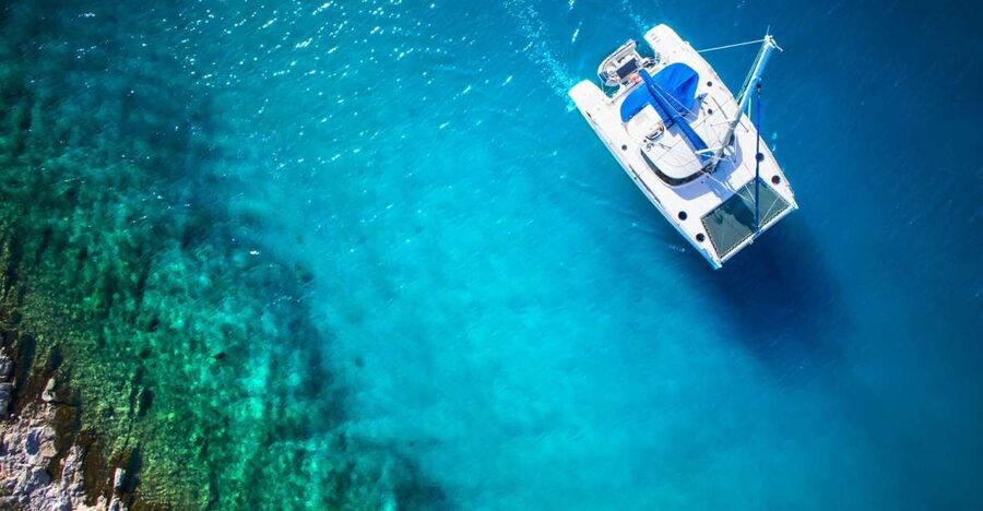 From Ornos: Mykonos Delos Catamaran Cruise with Meal & SUP - Passing Delos without stepping ashore