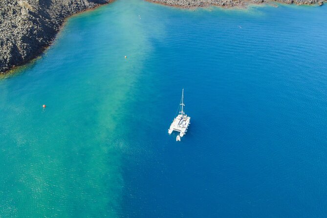 Full Day Santorini Catamaran Private Cruise with meal and transfer - Faros lighthouse and Indian Head Rock