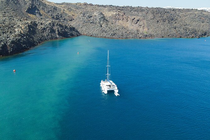 Full Day Santorini Catamaran Private Cruise with meal and transfer - Palea Kameni and the dark volcanic islands