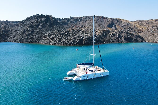 Full Day Santorini Catamaran Private Cruise with meal and transfer - Oia, Fira, and the old port from below