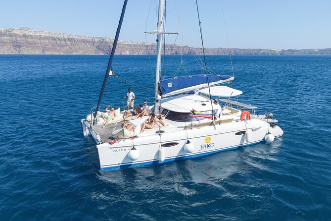 Full Day Santorini Catamaran Private Cruise with meal and transfer - Red Beach: volcanic color from the water