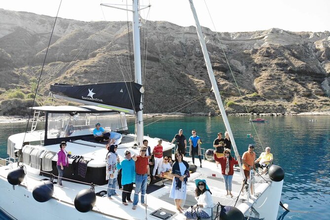 Half-Day Exclusive Catamaran Cruise in Santorini with Meal and Open Bar - White Beach and the Venetian Lighthouse pass by