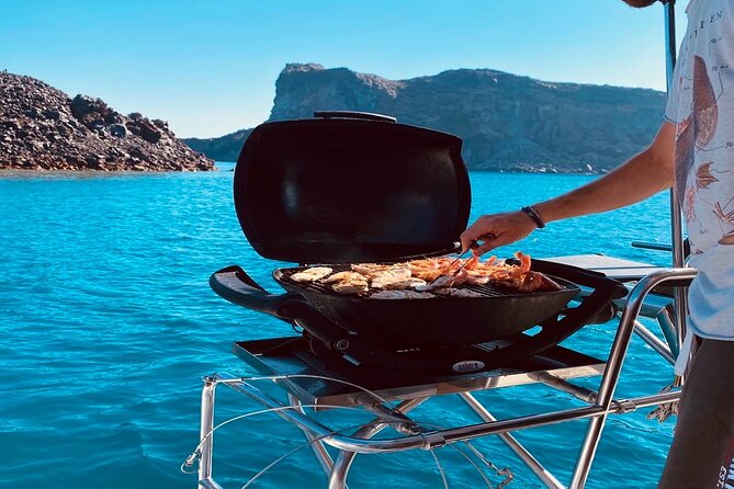 Half-Day Exclusive Catamaran Cruise in Santorini with Meal and Open Bar - The volcano stop is warm, but not a spa