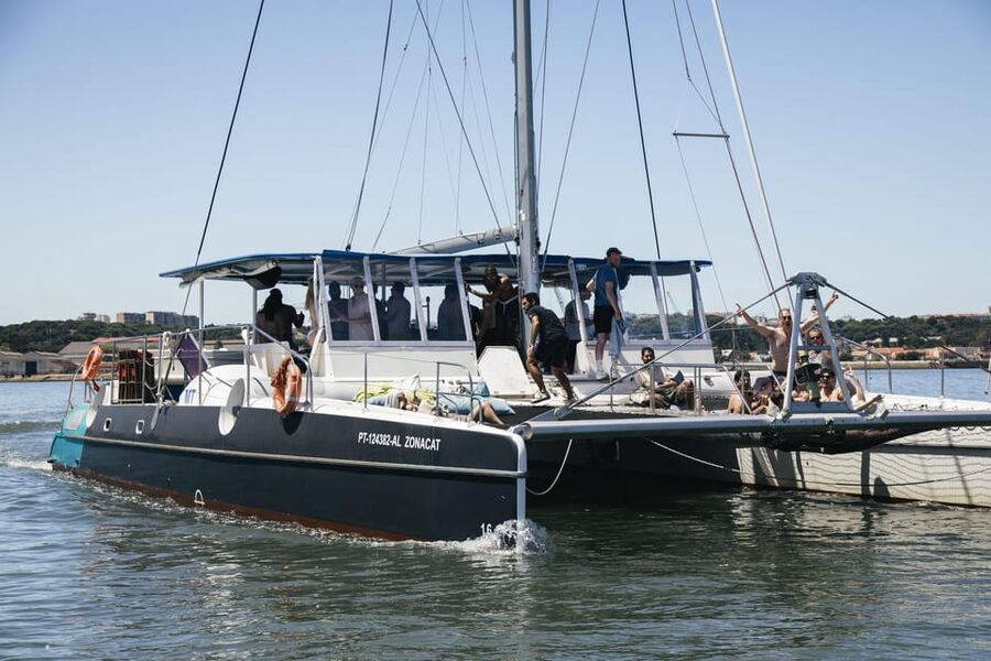 Lisbon: Catamaran Boat Party with Music, Open Bar & Dives - Cruising toward Algés and Belém