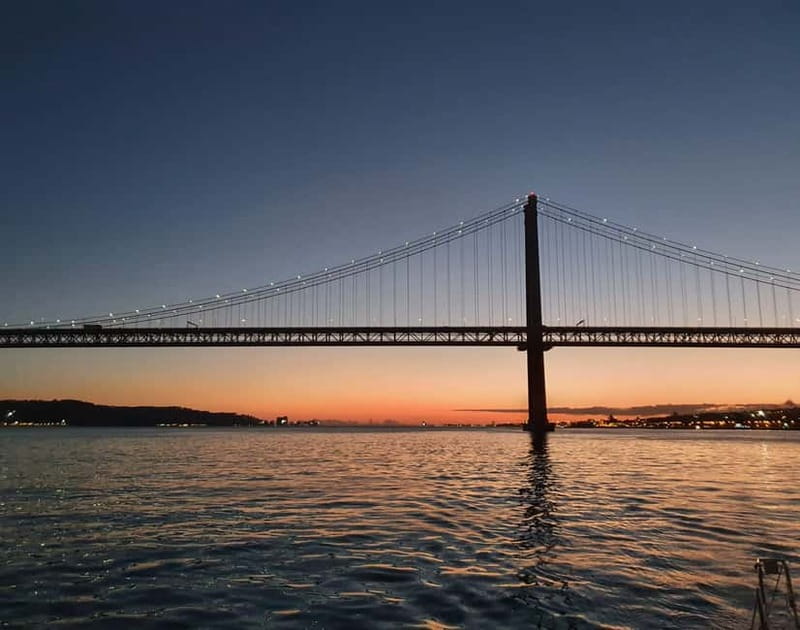 Lisbon: Catamaran Cruise with Drinks & Pastel de Nata - Sunset colors, blankets, and the open deck