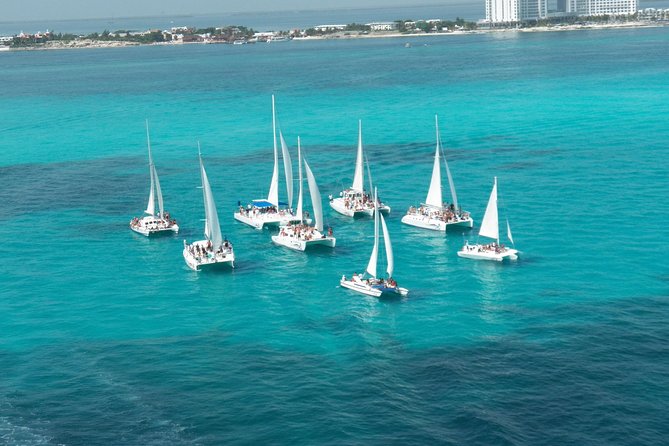Live this unique experience. Catamaran to Isla Mujeres Tour. Open Bar included. - Buffet lunch and private beach-club time