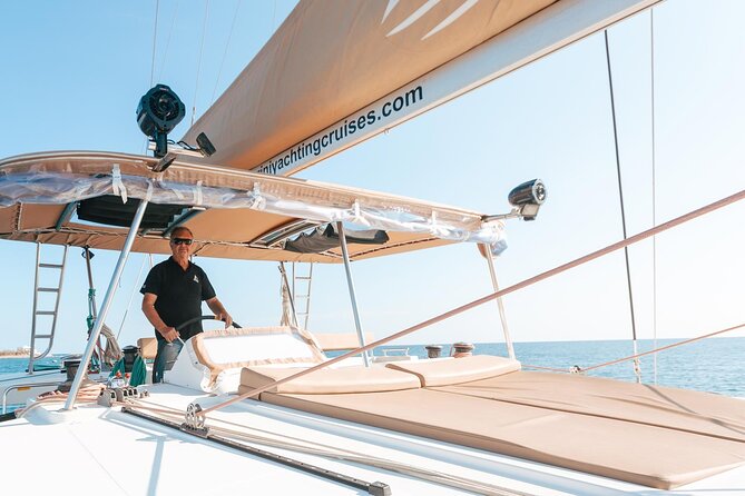 Luxury Santorini Catamaran Cruise: Lunch, BBQ, Drinks, Transfers - Sailing past Red Beach and Akrotiri Lighthouse
