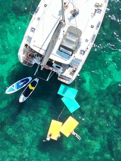 Majorca: Dinner aboard a private catamaran with snorkeling and paddle surfing - One hour for swimming, snorkeling, and paddle surfing