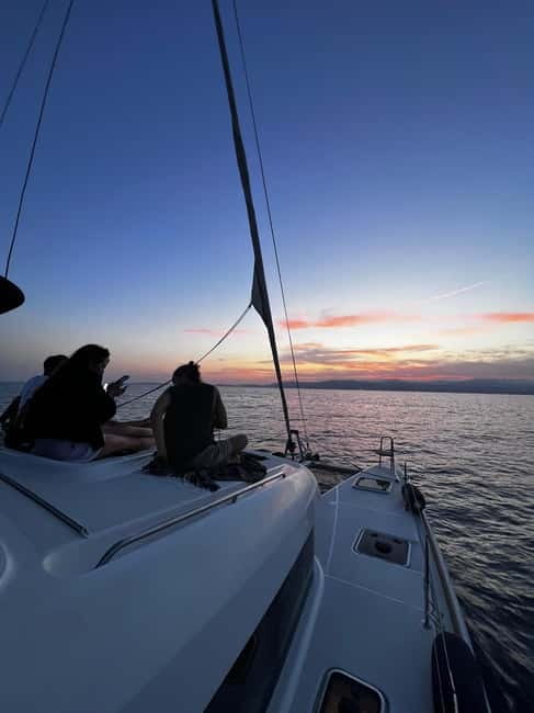 Majorca: Dinner aboard a private catamaran with snorkeling and paddle surfing - A short sail before dinner
