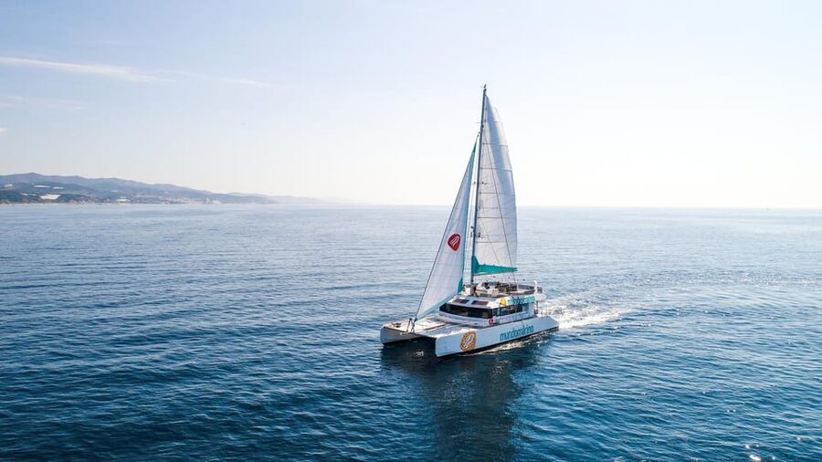 Malaga: Sailing Catamaran with Swimming and Paella Lunch - Leaving Malaga behind by catamaran