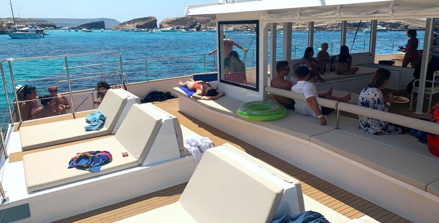 Malta: Blue Lagoon Evening Catamaran Cruise - An evening party atmosphere on the Sea Breeze