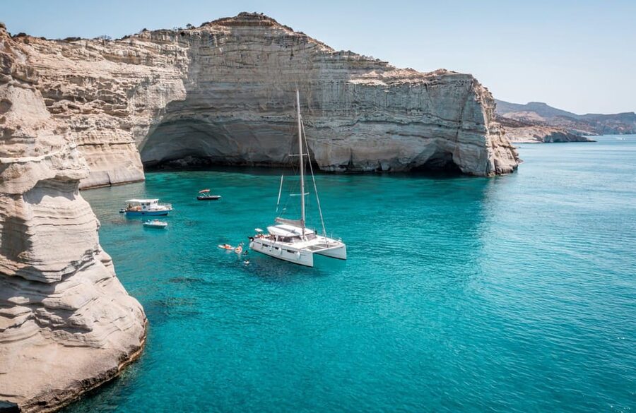 Milos: Full Day Luxury Catamaran with Full Meal & Open Bar - Leaving Adamantas with coffee and sea views