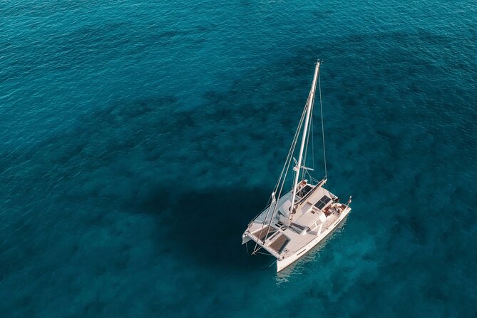 Mykonos: Private Catamaran Cruise—Hotel Pickup, BBQ & Drinks - Rineia: Four Hours Around Quiet Water