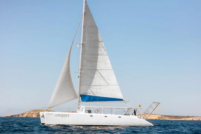 Ocean Catamaran Cruise Ibiza with Unlimited Drinks and BBQ - Cala Bassa and the clear-water swim stop