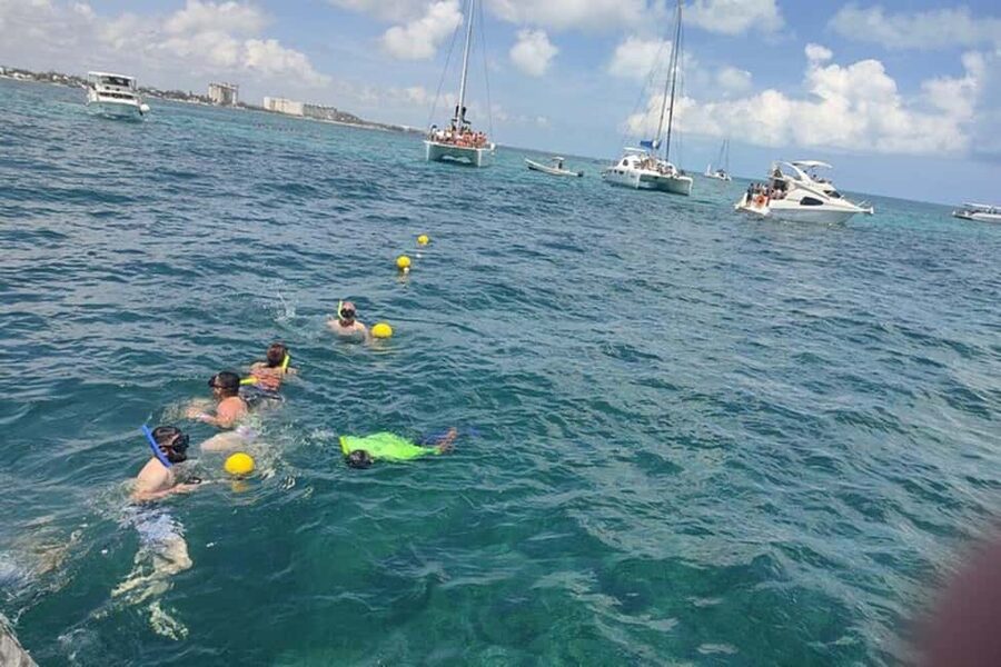 PDC: Isla Mujeres Catamaran Tour with Snorkeling - Sailing toward Isla Mujeres with music and an open bar