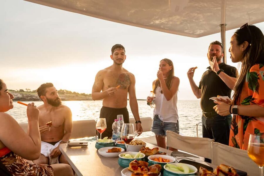 Polignano a Mare: Catamaran Tour with Aperitif & Local Food - The first coastal stops: caves, cliffs, and old-town views