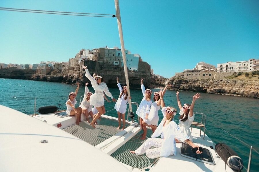 Polignano: Catamaran Cruise with Aperitif and Food - Following the cliffs past Grotta Palazzese and Lama Monachile