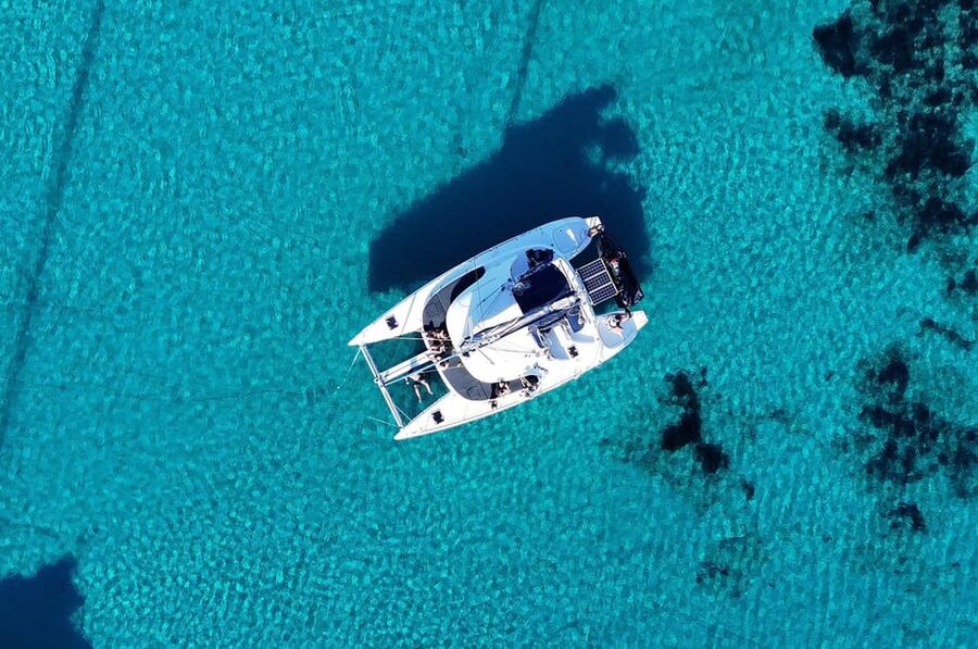 Private Catamaran Cruise Mykonos Delos with Meals & SUP - Rhenia’s coves and clear water