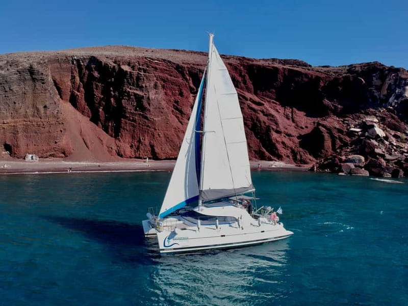 Santorini: Catamaran Cruise with Food and Drinks - Red Beach, Santorini’s red volcanic cliffs