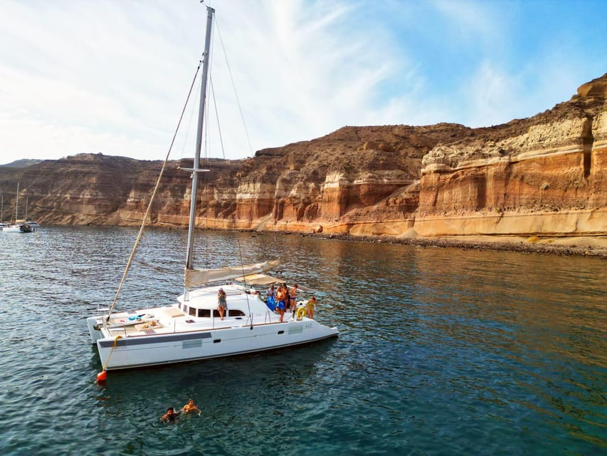 Santorini: Catamaran Cruise with Greek BBQ and Drinks - Red Beach: volcanic cliffs and your first swim