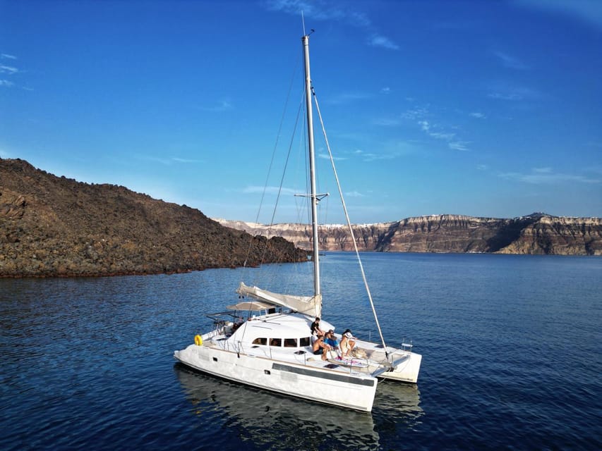 Santorini: Catamaran Cruise with Greek BBQ and Drinks - Indian Rocks and the Venetian Lighthouse