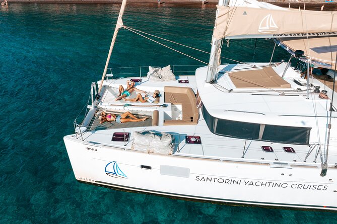 Santorini Catamaran Cruise: with Lunch, BBQ, Open Bar, Transfers - Red Beach gives the morning its first big view