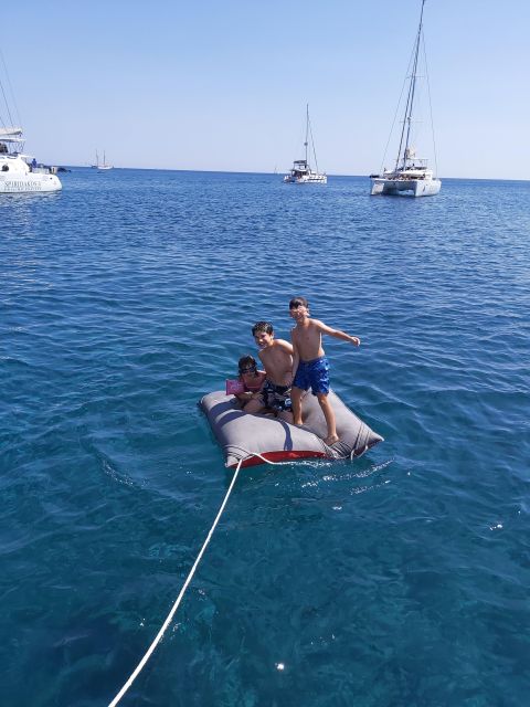 Santorini:Catamaran: private cruise with food & drinks - White Beach, Black Mountain, and Indian rock