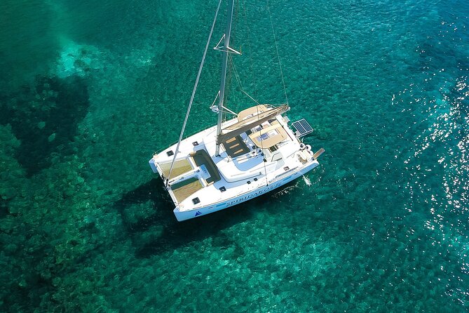 Santorini Classic Catamaran Cruise with BBQ, Drinks and Transfers - White Beach and the Aegean rock formations