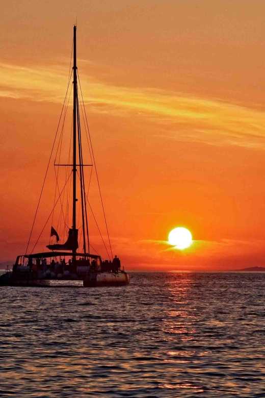 Santorini: Cruise Catamaran with BBQ & Drinks Day or Sunset - White Beach, barbecue, and drinks onboard
