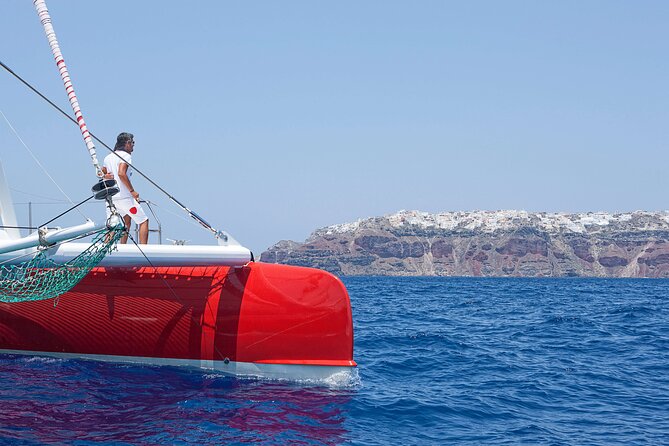 Santorini Cruise on Catamaran with BBQ & Open Bar - Red Beach from the water