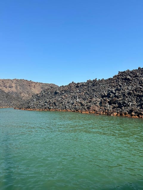 Santorini:Cruises with Catamaran around the Volcanic Island. - Black Mountain and the lighthouse add variety