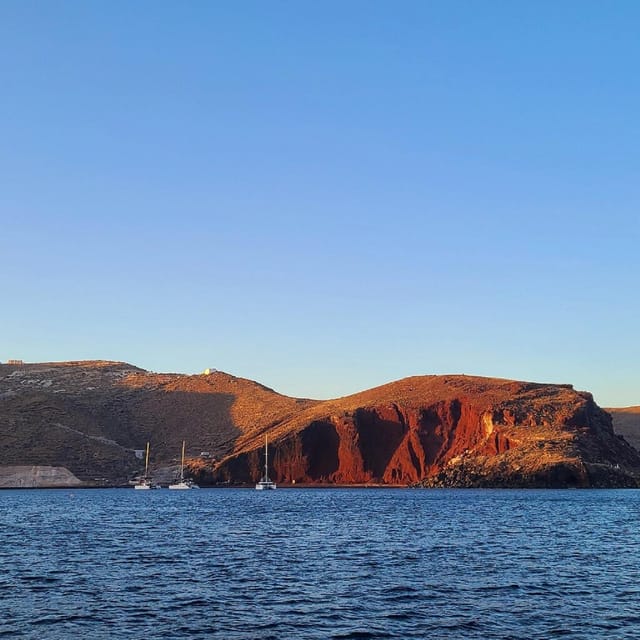 Santorini:Cruises with Catamaran around the Volcanic Island. - Red Beach gives you the first volcanic view