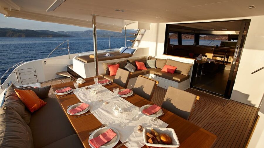 Santorini: Luxurious Catamaran Cruise with Meal & Open Bar - From Amoudi Bay toward the volcanic coast