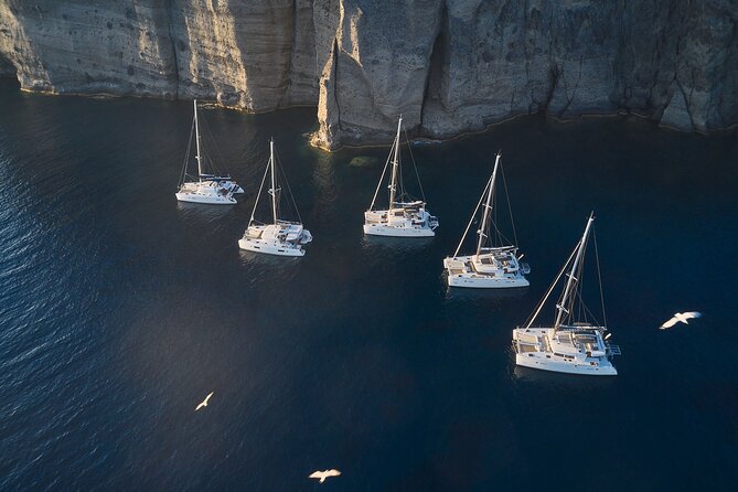 Santorini: Luxury Catamaran Cruise with Fresh Fish BBQ & Drinks - Sunset, Swimming, and the Pace of the Boat