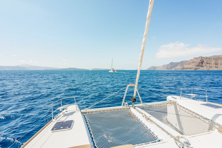 Santorini: Luxury Catamaran Day Trip with Meal and Open Bar - From hotel pickup to the Athinios port