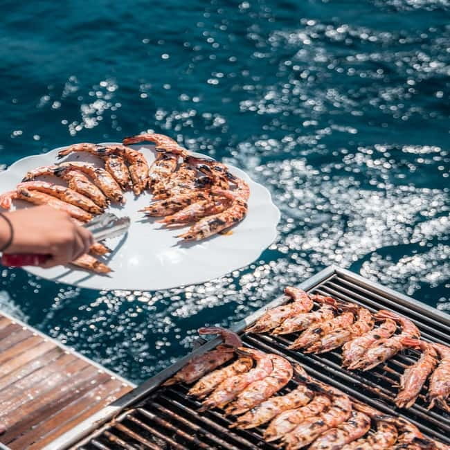 Santorini: Majestic Catamaran Cruise with Meal and Drinks - Swimming, sunbathing, and time on deck