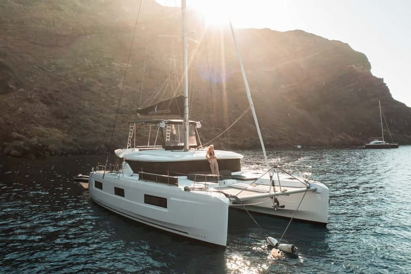 Santorini: Majestic Catamaran Cruise with Meal and Drinks - Leaving Ammoudi Bay for the caldera