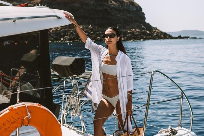 Santorini Oia: Private Sunset Catamaran Cruise with BBQ & Drinks - The lighthouse and southern coast widen the view