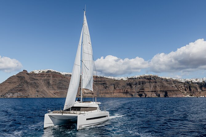 Shared Catamaran Half Day Cruise in Santorini - Passing the Akrotiri Lighthouse