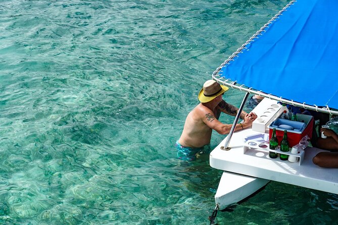 Snorkeling and Swimming on a Caribbean Cruise by Sharky Catamarans - Swimming with a drink at Coyote floating bar